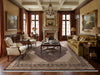 Load image into Gallery viewer, The rug is placed in a luxurious living room.