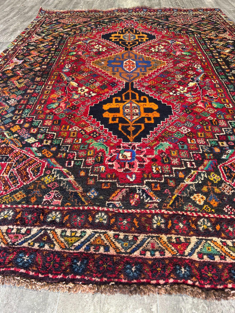 Red and navy tribal medallion area rug close-up of geometric pattern #P1200