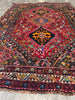 Load image into Gallery viewer, Red and navy tribal medallion area rug close-up of geometric pattern #P1200