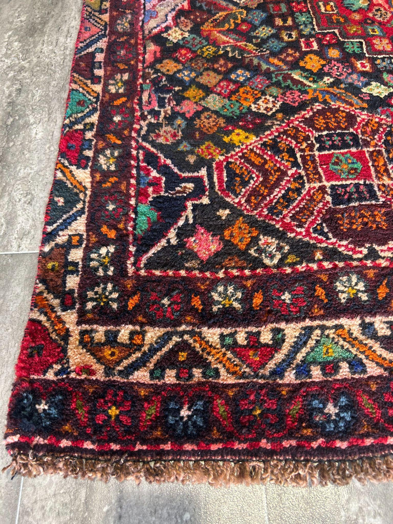 Detail of 5x7 tribal rug navy border and red field #P1200