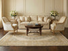 Load image into Gallery viewer, Living room with beige sofa, armchairs, and a coffee table on a patterned rug.